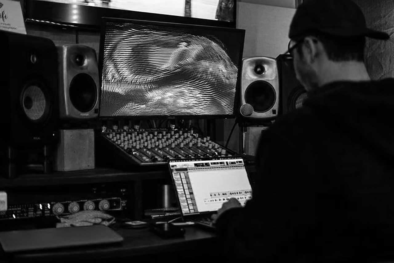 Jimmy working on mixing a song at the studio.